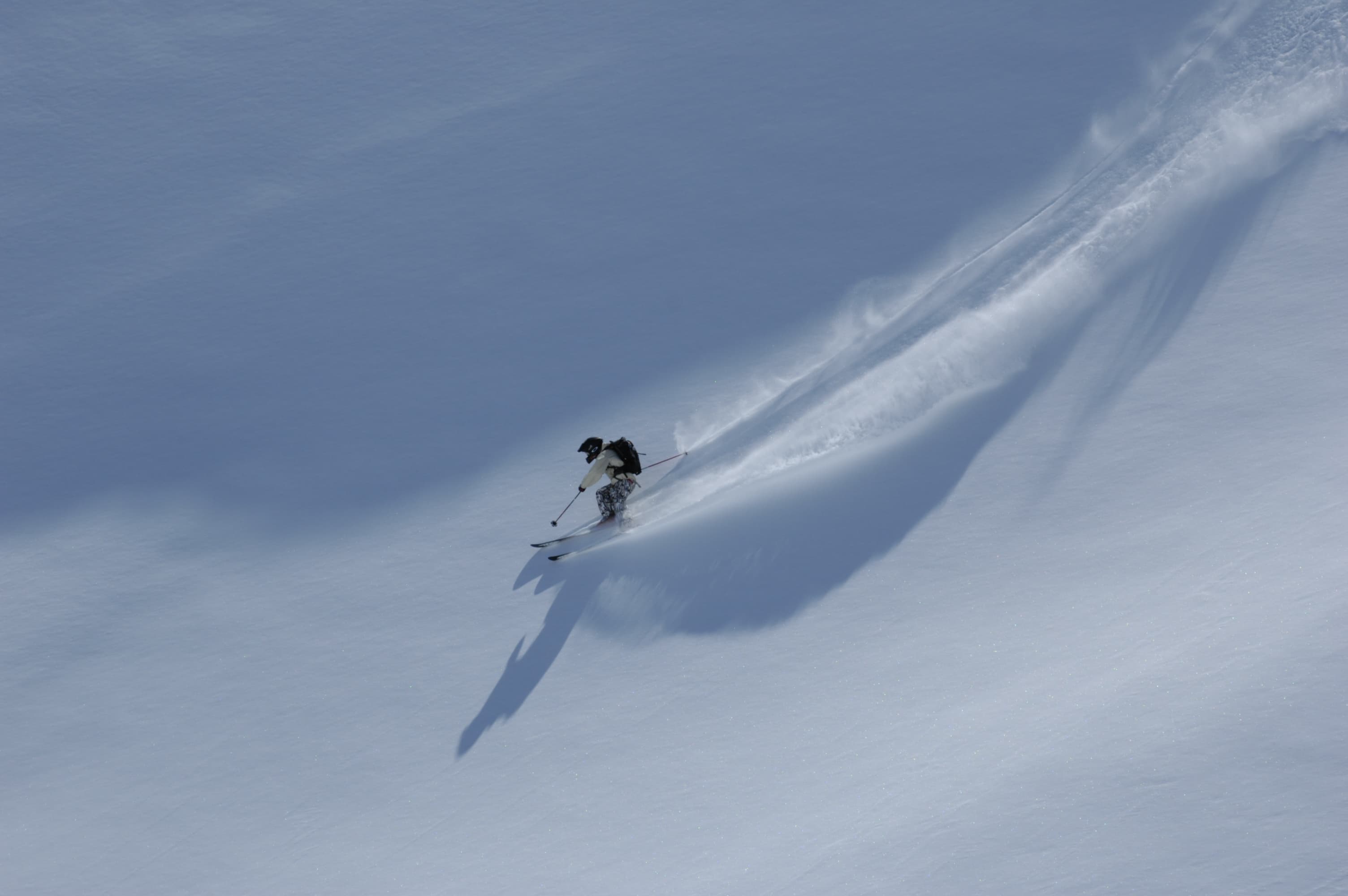 Skiier skiing down off piste slope